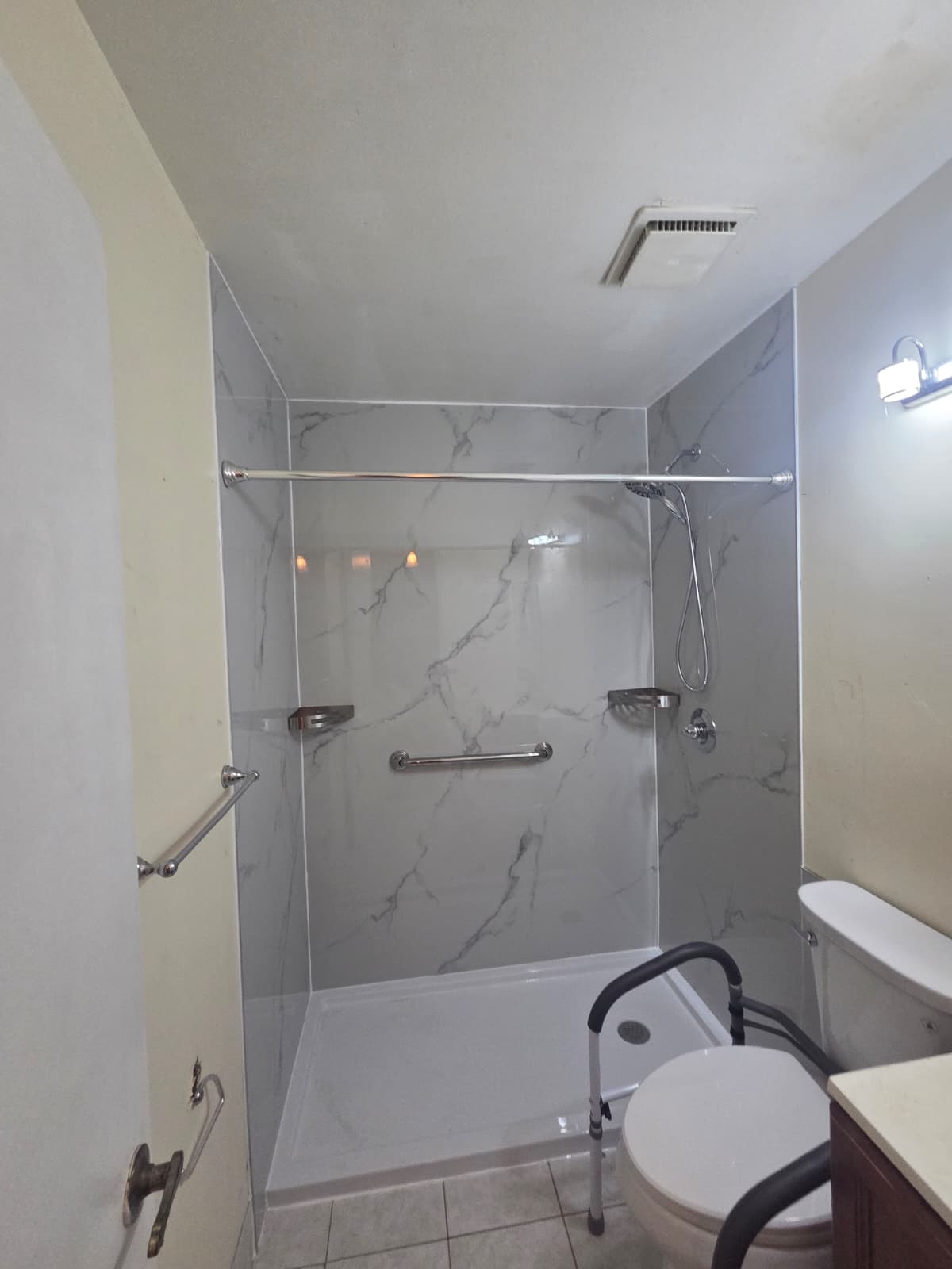 Completed tub-to-shower and walk-in shower project view 19